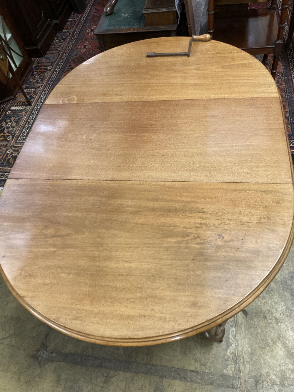A Victorian mahogany oval extending dining table, with two spare leaves, 220cm extended, width 120cm, height 72cm